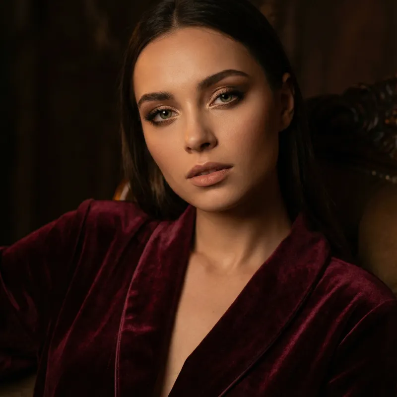 Elena in velvet gold setting with sensual lighting